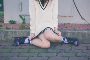 Detail of a girl posing in an urban context