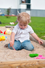 Child playing on playground in sandbox