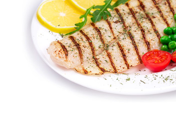 Grilled fish fillet with vegetables.
