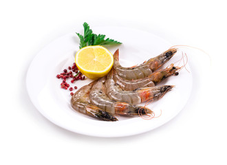Raw shrimps on white plate.