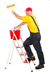 Worker on ladder with roller.