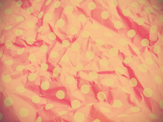 Pink wrinkled paper with polka dot pattern