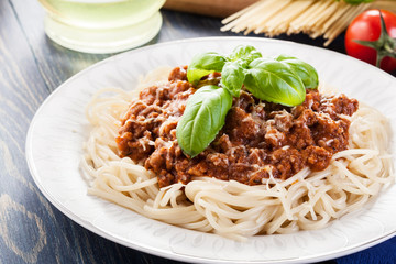 Spaghetti bolognese with cheese and basil