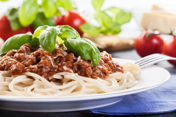Spaghetti bolognese with cheese and basil