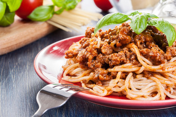 Spaghetti bolognese with cheese and basil