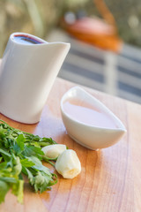 parsley and garlic on wooden cutting board, cooking time backgro
