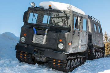 articulated military tracked cargo vehicle on snow