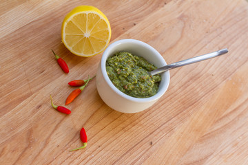 lemon, chilli pepper and source on wooden cutting board, cooking