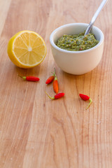lemon, chilli pepper and source on wooden cutting board, cooking