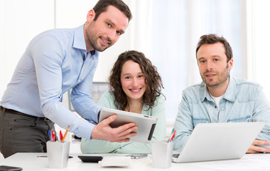 Two interns working together assisted by their course supervisor