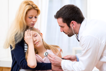 Doctor listening heart beatment of little girl