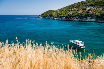 Beautiful scenery with blue sea and boat anchored near the shore