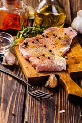 Raw pork slices prepared for roast with spices