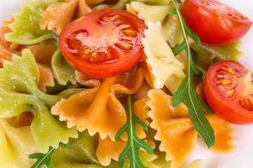 Pasta with arugula tomato and cheese.