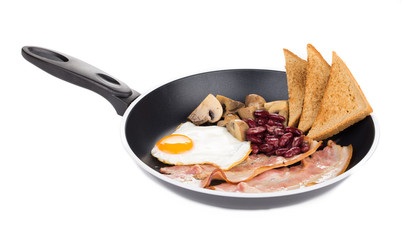 Fried egg with bacon in a frying pan.