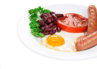 Fried egg with sausage on plate.