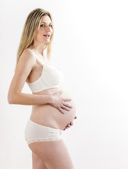portrait of standing pregnant woman wearing lingerie