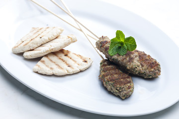 mutton kebab with mint and pita bread