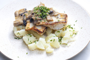 pikeperch on butter with mushroom sauce and spring potatoes
