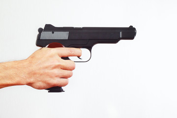 Hand with semi-automatic gun on a white background