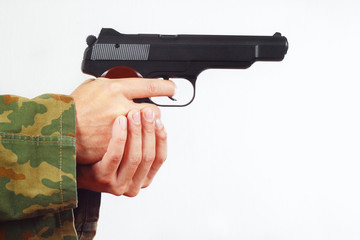 Hands in camouflage uniform with semi-automatic gun