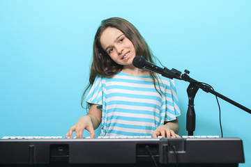 Young girl play digital  piano