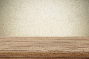 Empty wooden table over cement wall background