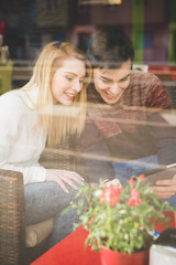 young beautiful couple lovers using tablet