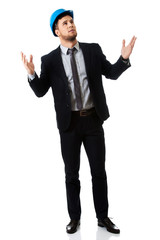 Businessman in hard hat holding copyspace.