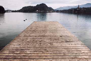 Wooden pier at the lake water..