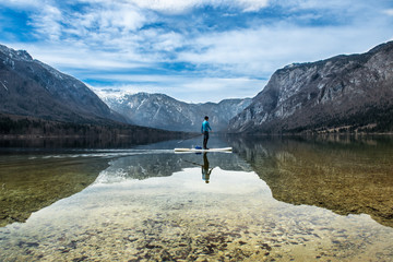 man on a canoe on a mountain lake