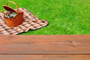 Foto op Canvas Picknick tafelblad close-up. Picknickmand en deken op het gazon © Alex
