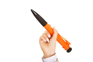 Businesswoman's hand pointing up with big pen.