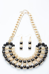 metal feminine necklace. on white background. earrings
