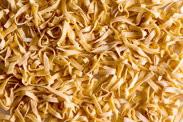 Background of freshly made fettuccine pasta