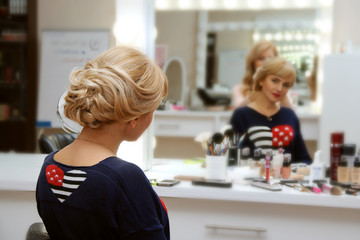 Girl doing her hair in the salon