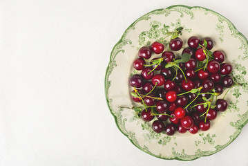 Red cherry on a white tablecloth