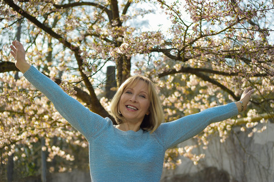 attractive mature woman enjoys the sunny day