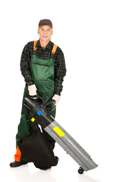 Worker In Uniform With A Leaf Blower