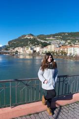 Fototapeta na wymiar Girl with Ventimiglia on the background