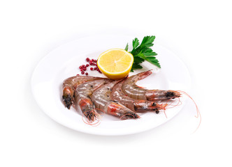Raw shrimps on white plate.