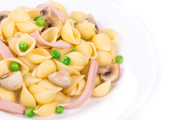 Pasta shells with vegetables and sausage.