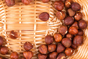 Close up of hazel nuts on a wicker basket.