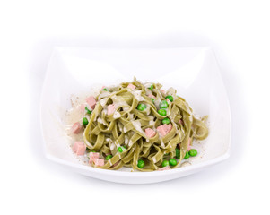 Pasta tagliatelle with green peas and ham.