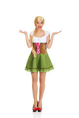 Fototapeta premium Woman wearing Bavarian dress with open hands.