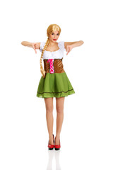 Woman in Bavarian dress with thumbs down.