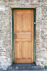 New Wooden Door And A Medieval Stone Wall