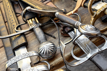 medieval swords on a wood table