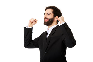 Businessman making fists in a winner gesture.