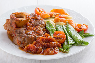 Ossobuco. Сross-cut veal shanks braised with vegetables.